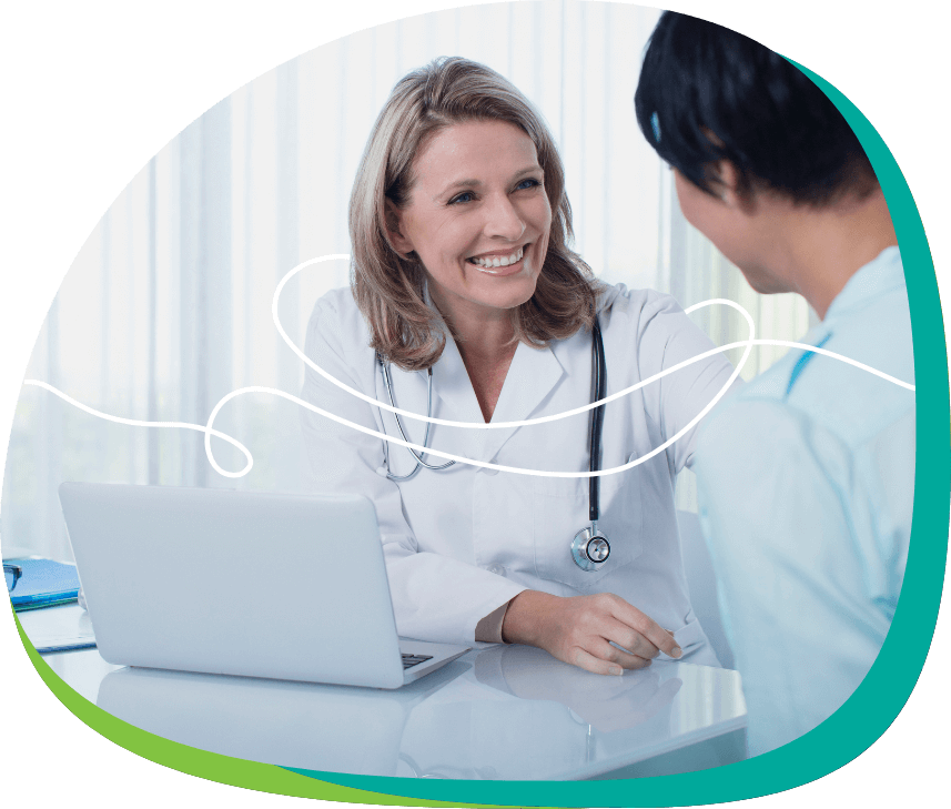 Doctor with long blond hair wearing stethoscope hearing heartbeat device talking with female patient in blue shirt